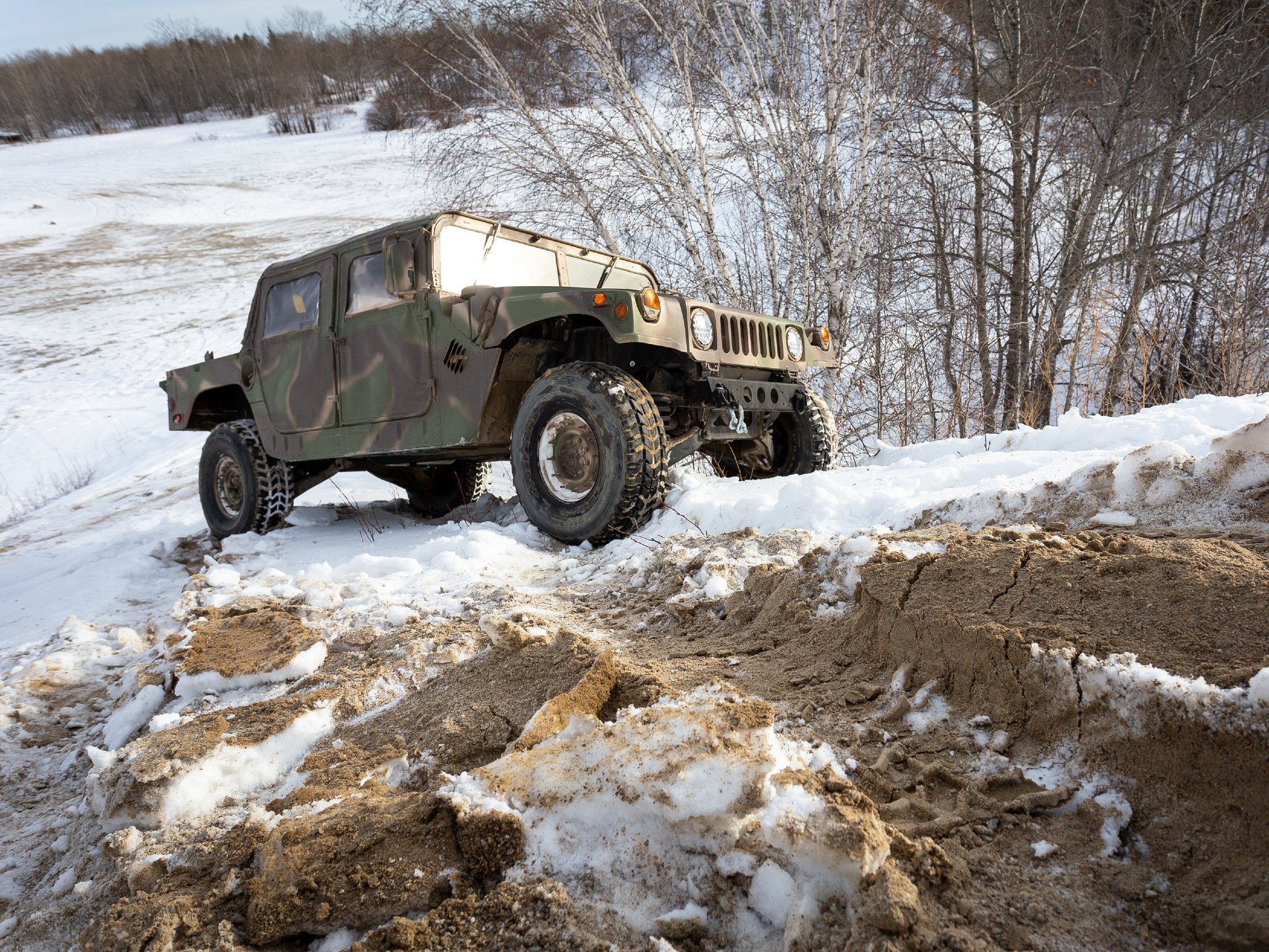 Troverlo tracked jeep driving down a snowy road.