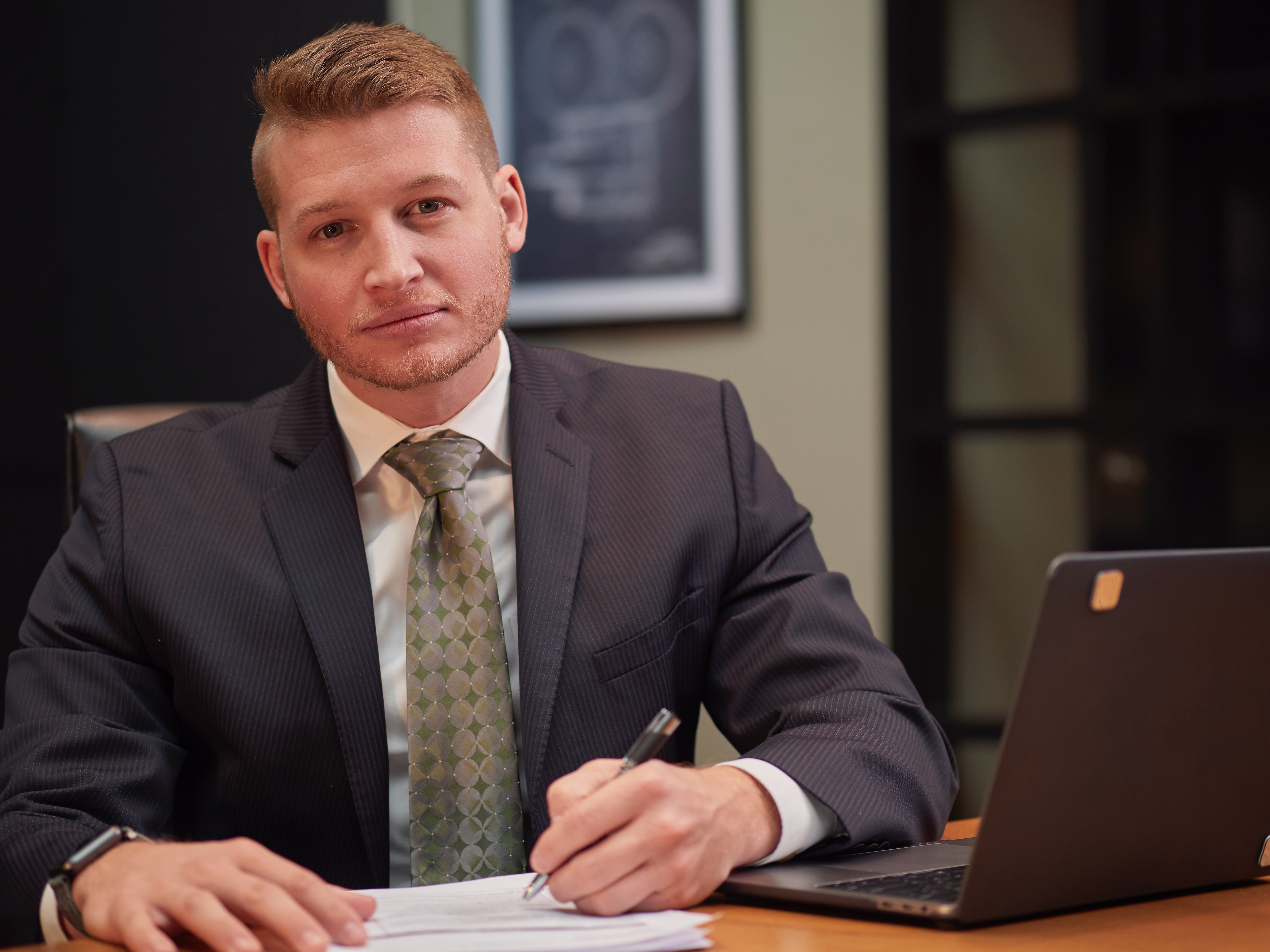 Banker sitting at a desk with a computer tracked by Troverlo